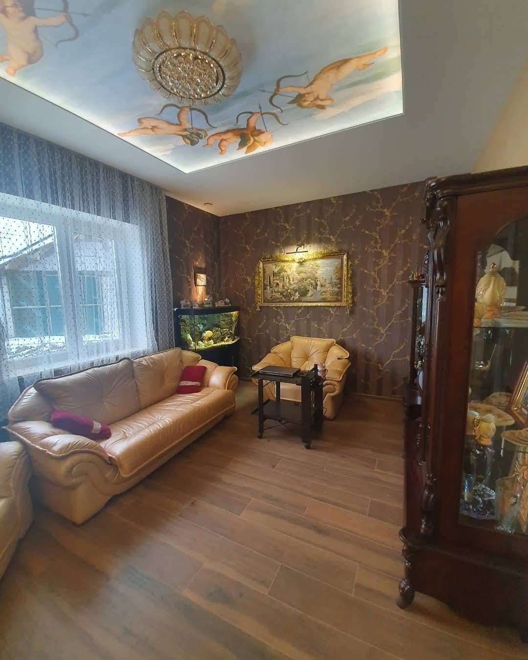 Ornate living room with painted ceiling and chandelier, earlier work