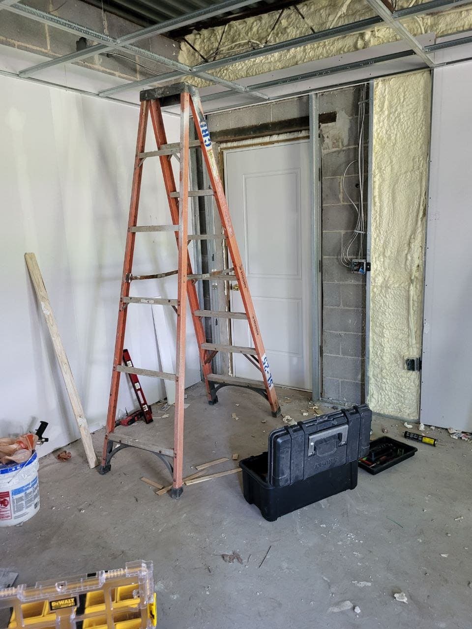 Basement remodel with steel ceiling grid and spray foam