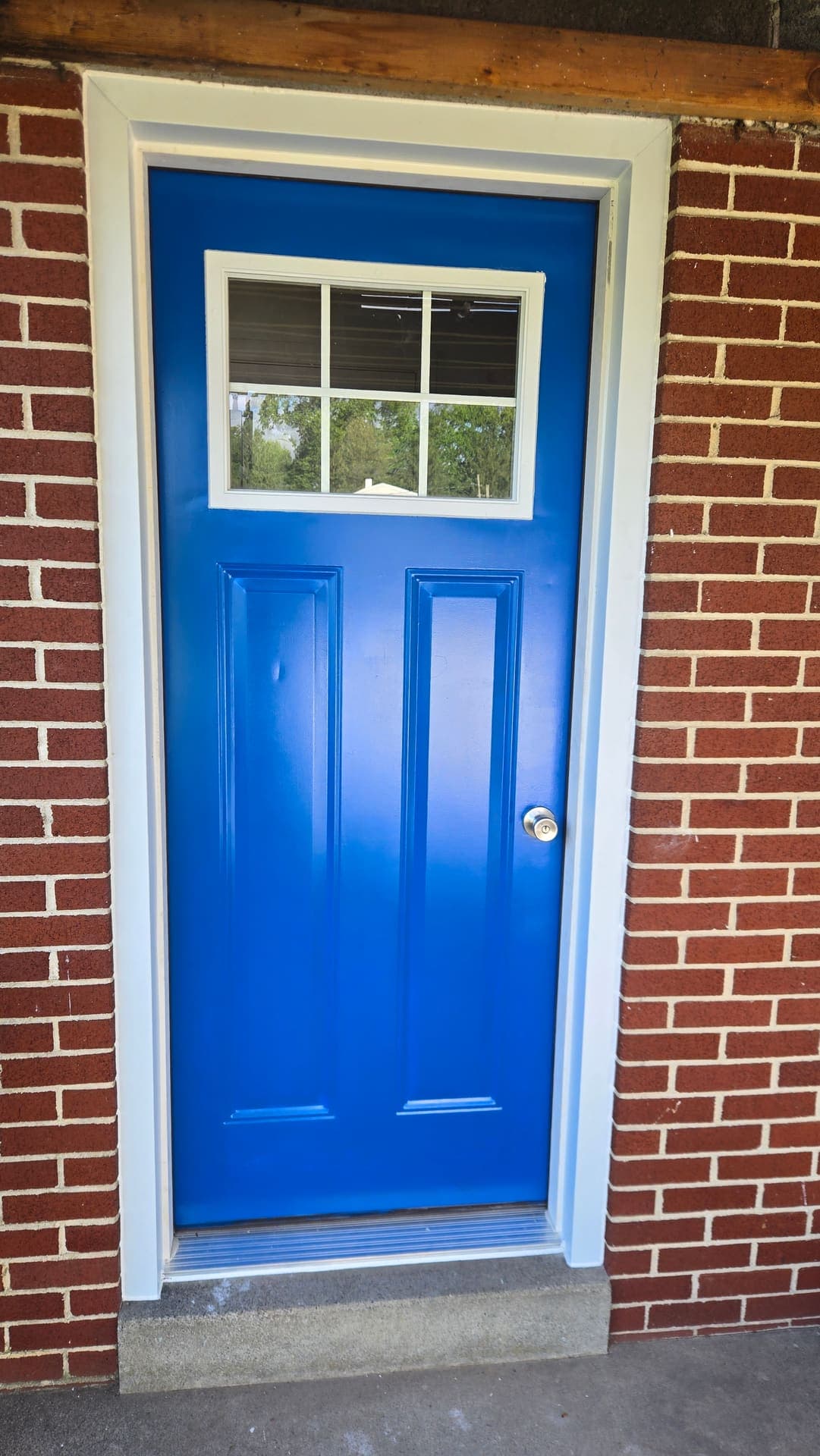 New blue front door with lite window and white trim
