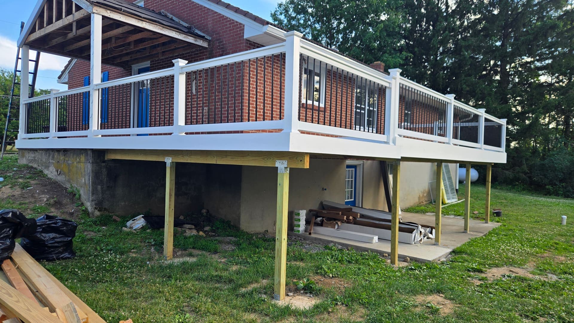 Corner view of a new elevated composite deck with white railing