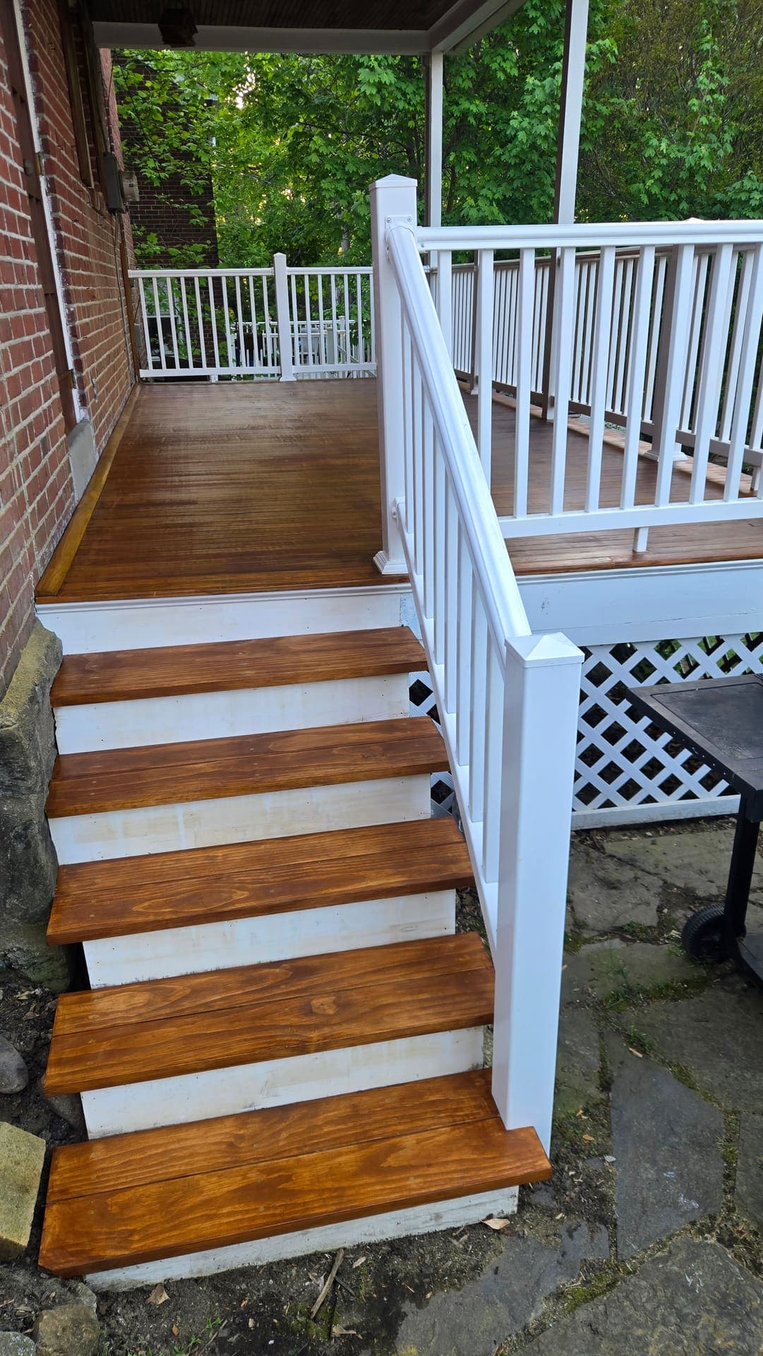 Freshly stained porch steps with white railings