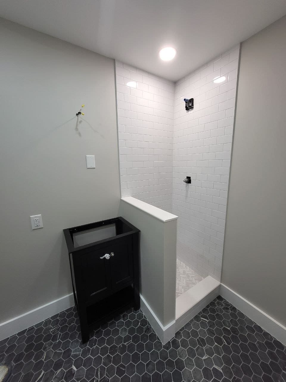 Subway tile shower and hex marble floor mid remodel