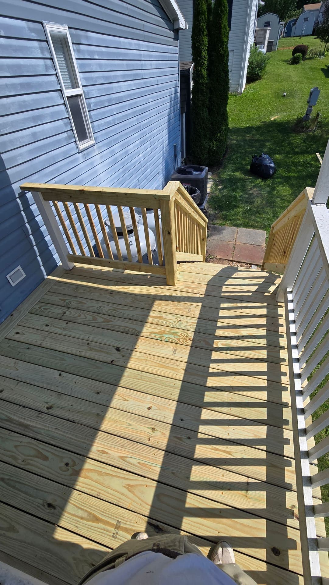 New treated wood landing with gate rail, top view