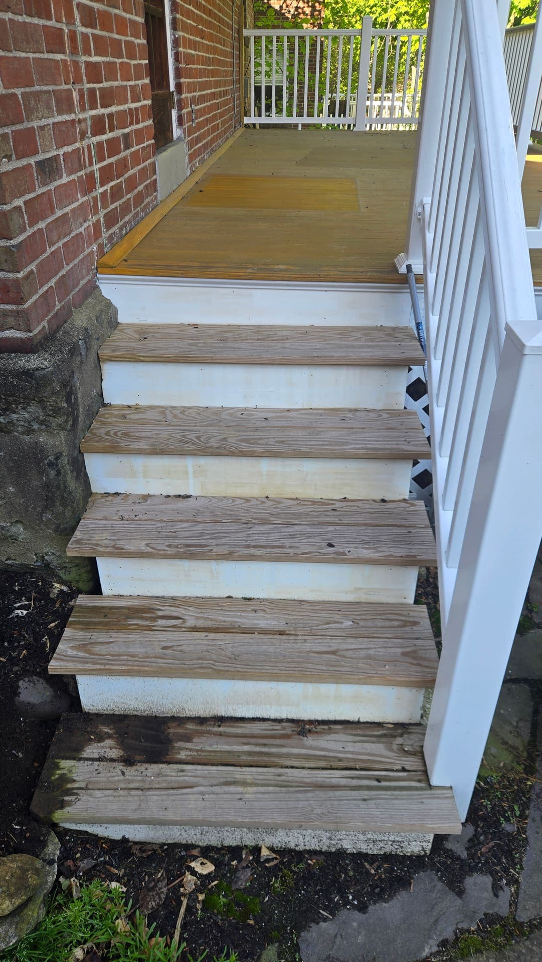 Weathered gray porch steps before refinishing