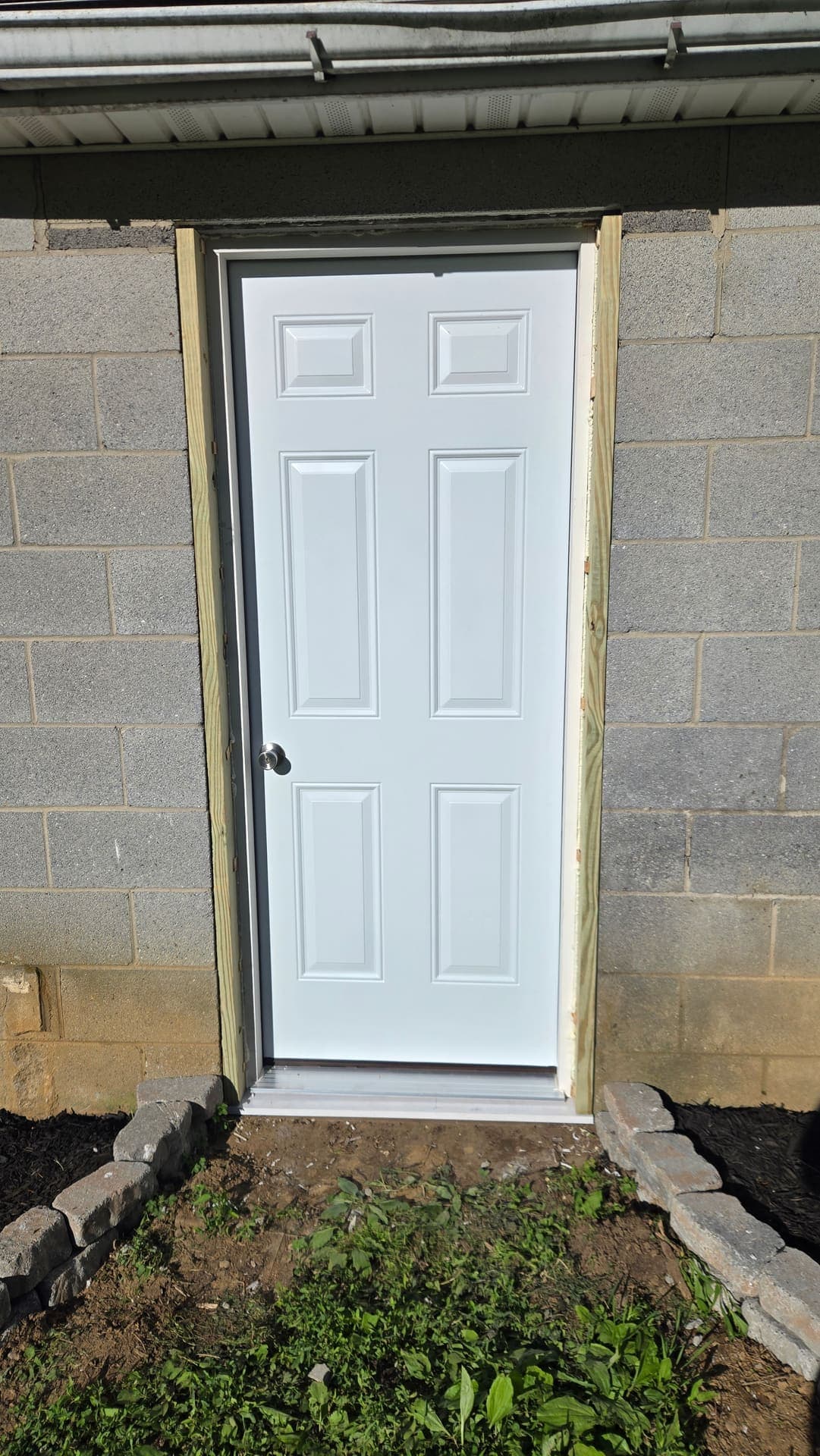 New white six panel entry door with paver walkway