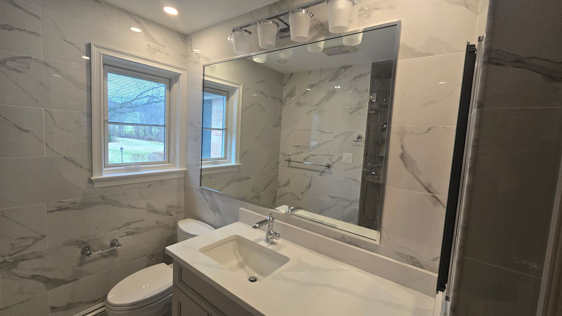 Finished bathroom remodel with marble tile and chrome fixtures, Lancaster County PA